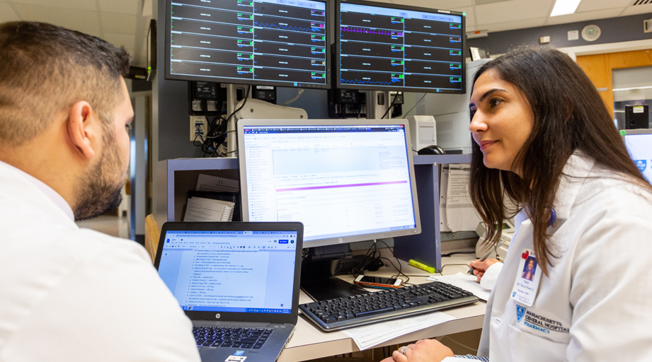 male and female pharmacists meeting at a workstation
